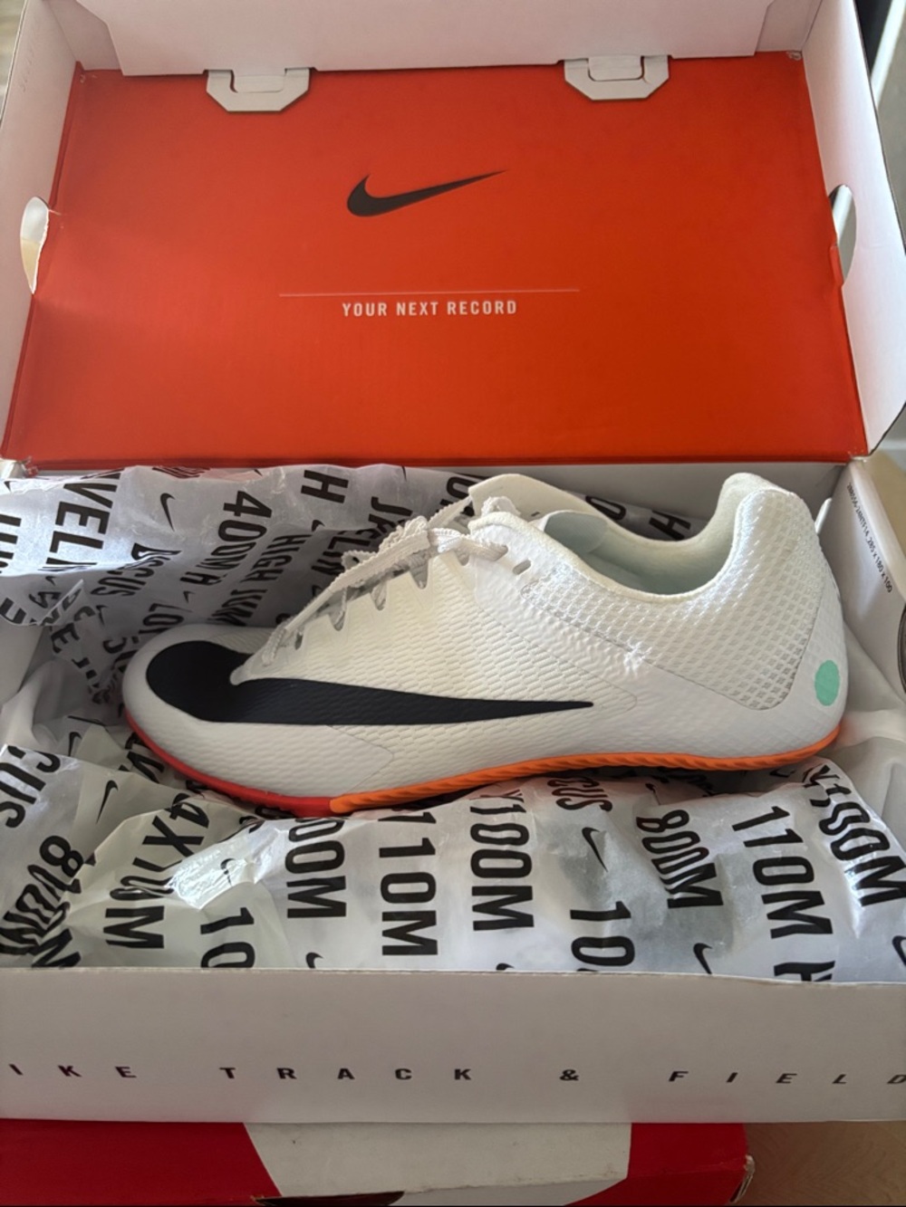 Nike White Racing Spike with Black Swoosh and Orange Outsole